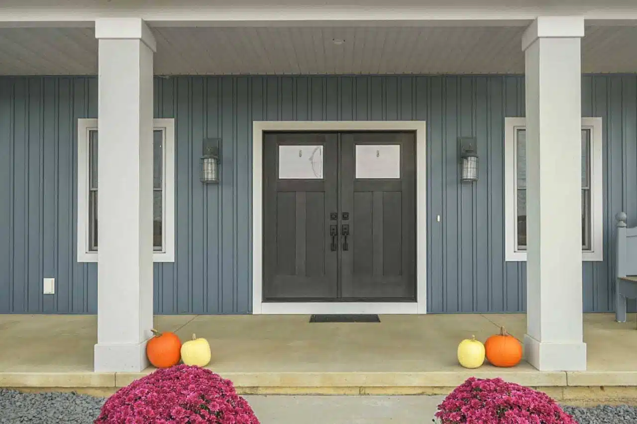 Exterior with blue siding and white trim of Ranch-style custom built Leesburg, IN home.