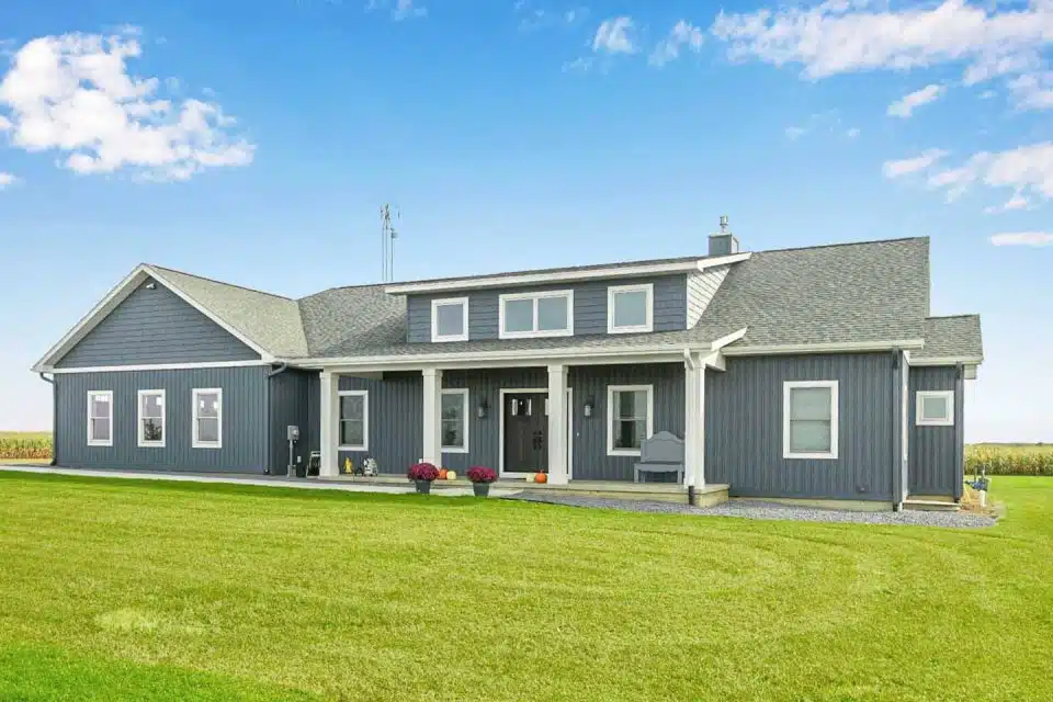 Exterior with blue siding and white trim of Ranch-style custom built Leesburg, IN home.