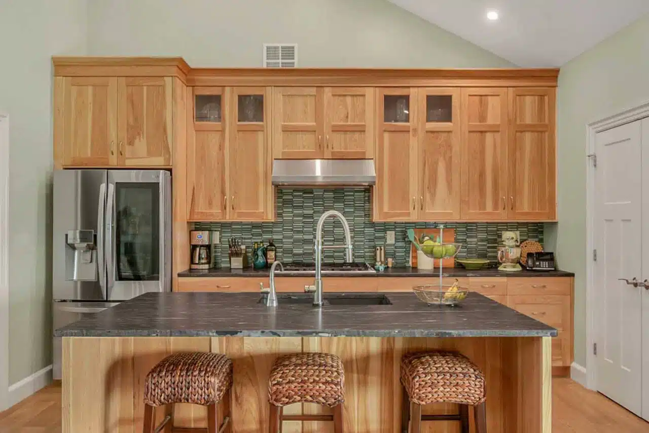 Ranch-style Leesburg, IN home kitchen remodel with natural wood cabinets.