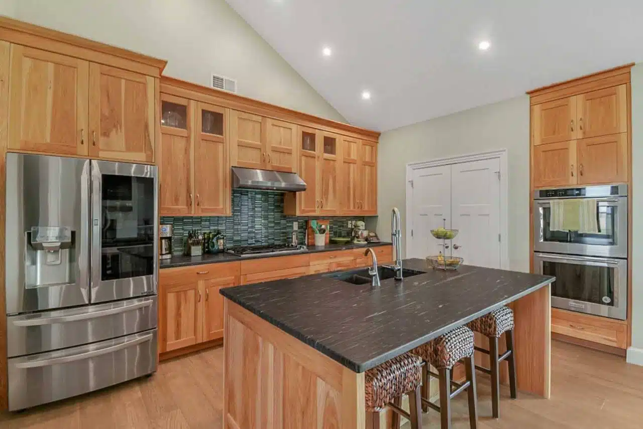 Ranch-style Leesburg, IN home kitchen remodel with natural wood cabinets.