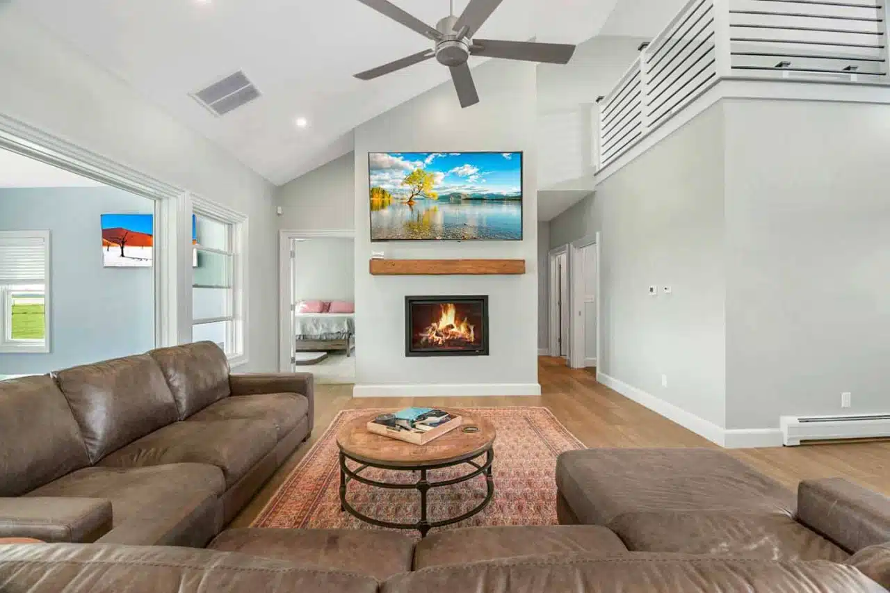 Seating area with gas fireplace insert and mounted TV in custom-built Leesburg, IN home.