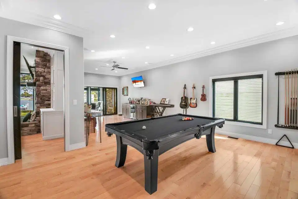 Game room, featuring a pool table at a custom-built home.